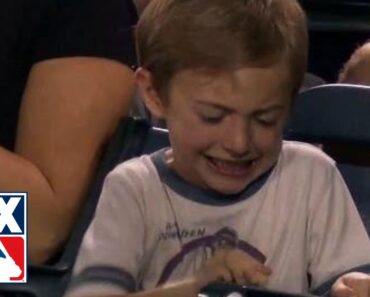 Kid struggles to crack peanut at Twins-Angels game